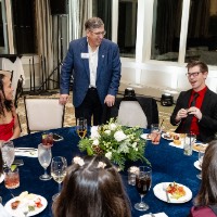 A group of people sitting a round table